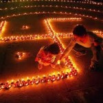 A girl lights a Diwali lamp or 'diya' as part of a swastika pattern for Hindu 'puja' - coming to a school near you!