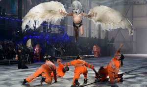 The dancers in orange jump-suits represent the five workers who died building the Gotthard Base Tunnel. As for the woman dressed as a bird?