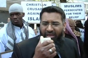 Michael Adebolajo stands behind Anjem Choudary at a rally held by the Muslim preacher.