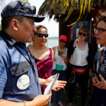 A guard faces members of Women on Waves, a Dutch non-profit that provides abortion services beyond the territorial waters of countries where abortion is illegal, in Puerto de San Jose