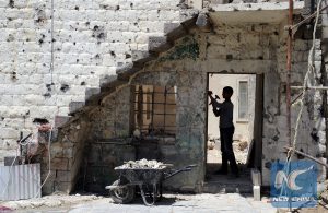 Rebuilding a shattered school in the old city of Homs.
