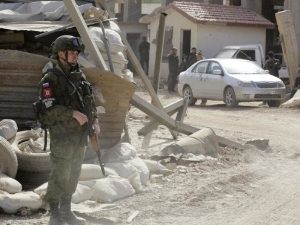 A Russian soldier stands at the entrance of Harasta in Eastern Ghouta, on the outskirts of Damascus, on March 22, 2018. Picture: AFP