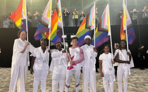 Tom Daley and others carrying 'Pride' flags into the Commonwealth Games