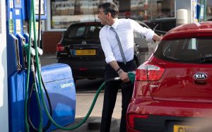 Rishi Sunak filling up someone else's car in a publicity stunt.