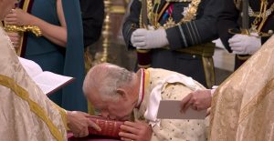 His Majesty King Charles III kisses the Bible at his Coronation in May 2023