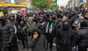 Masked Muslim youths take to east London streets to 'defend our community' after police banned UKIP march to 'reclaim' the area | Daily Mail Online