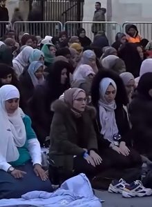 Muslim Women ion Islamic dress praying separately from the men in Trafalgar Square.
