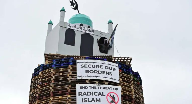 Northern Ireland man arrested for suspected hate crime after replica mosque placed on top of bonfire